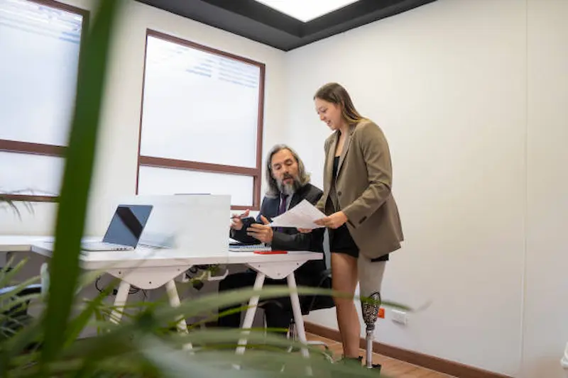 Legal expert analyzing machinery logs and workplace documents related to a traumatic amputation case