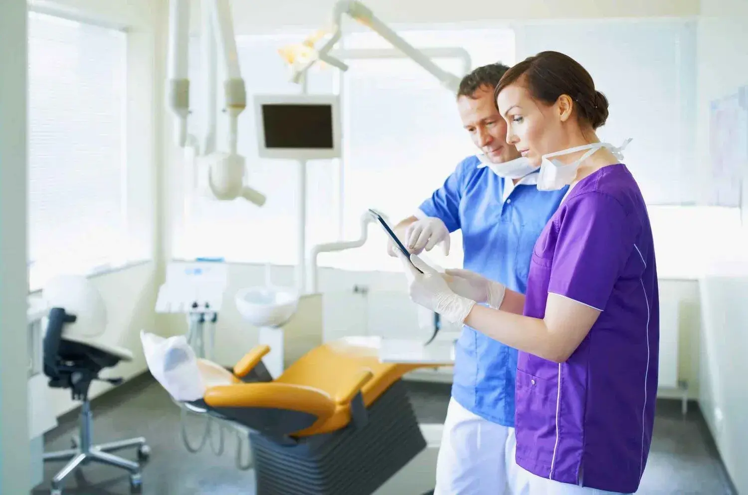 “Dental malpractice lawyer reviewing dental records with an injured patient.”