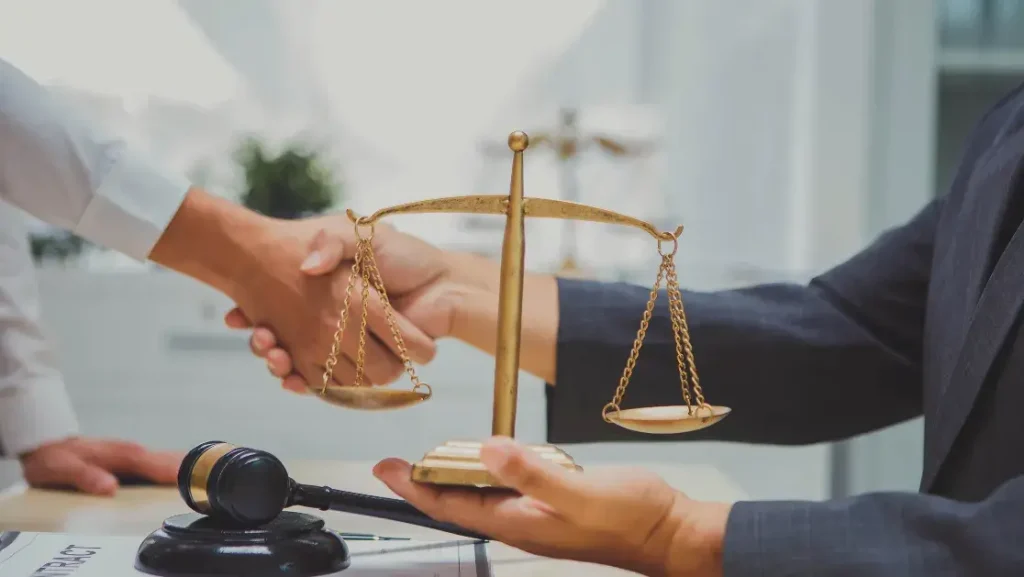 Paralysis injury lawyer reviewing case documents with a client in a law office"