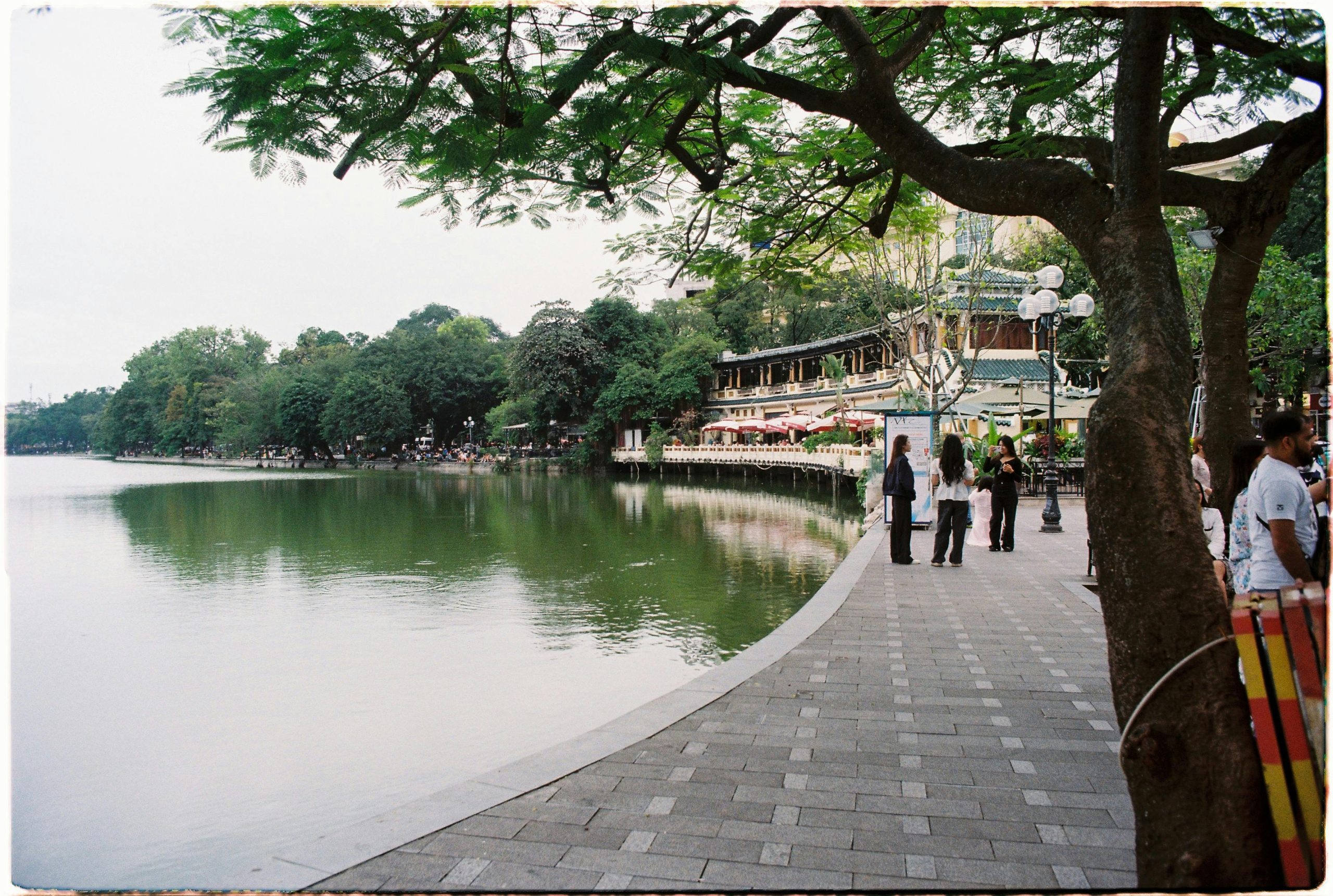 Public park accident – injured visitor receiving assistance near broken playground equipment in a city park.